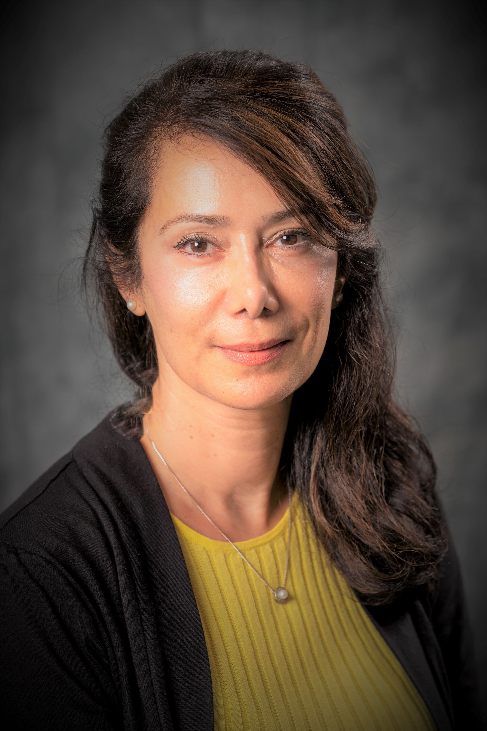 Soraya Zabihi, smiling and wearing a yellow sweater