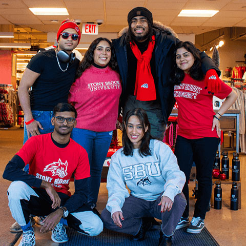 A group of students in the Shop Red West store dressed in Stony Brook gear