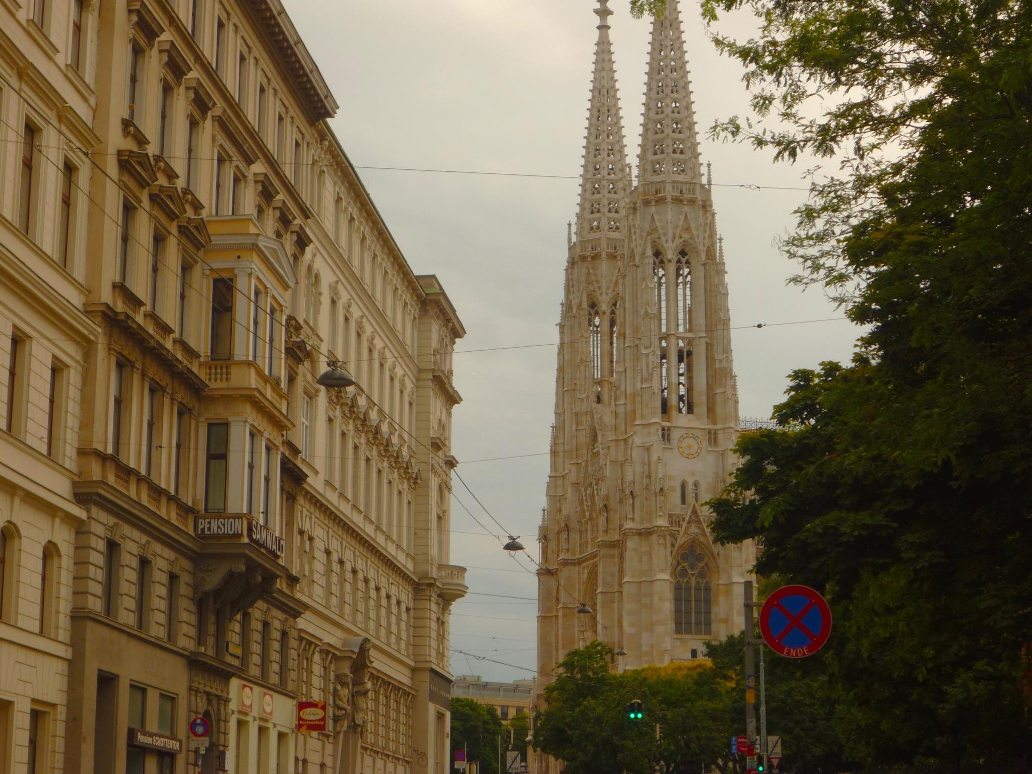 Vienna Church View of Votive Church's spire between classic European architecture on a cloudy day in Vienna.