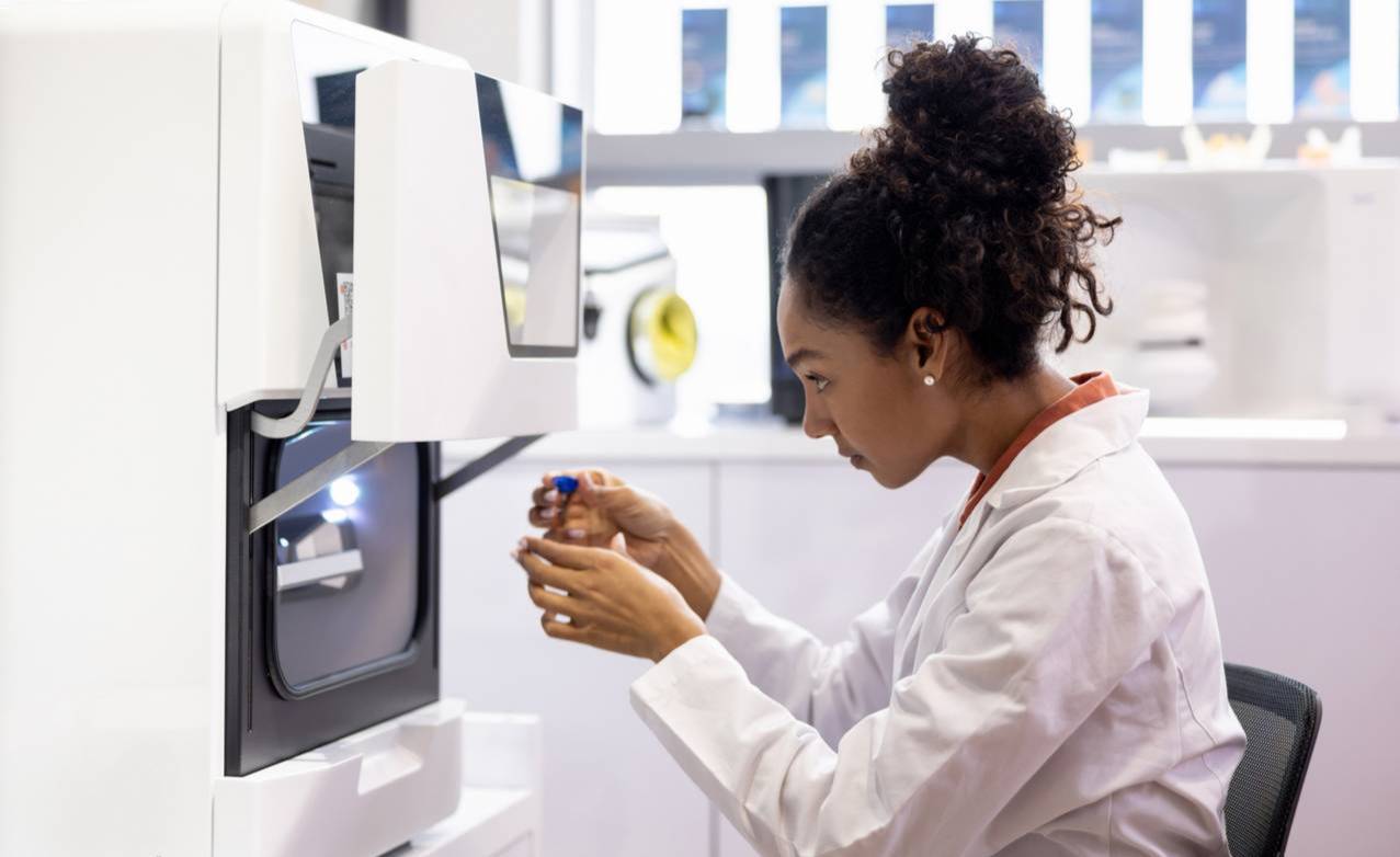A high schooler working with a medical 3D printing machine